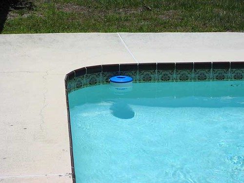 blue chlorine tablet floater drifting in a pool