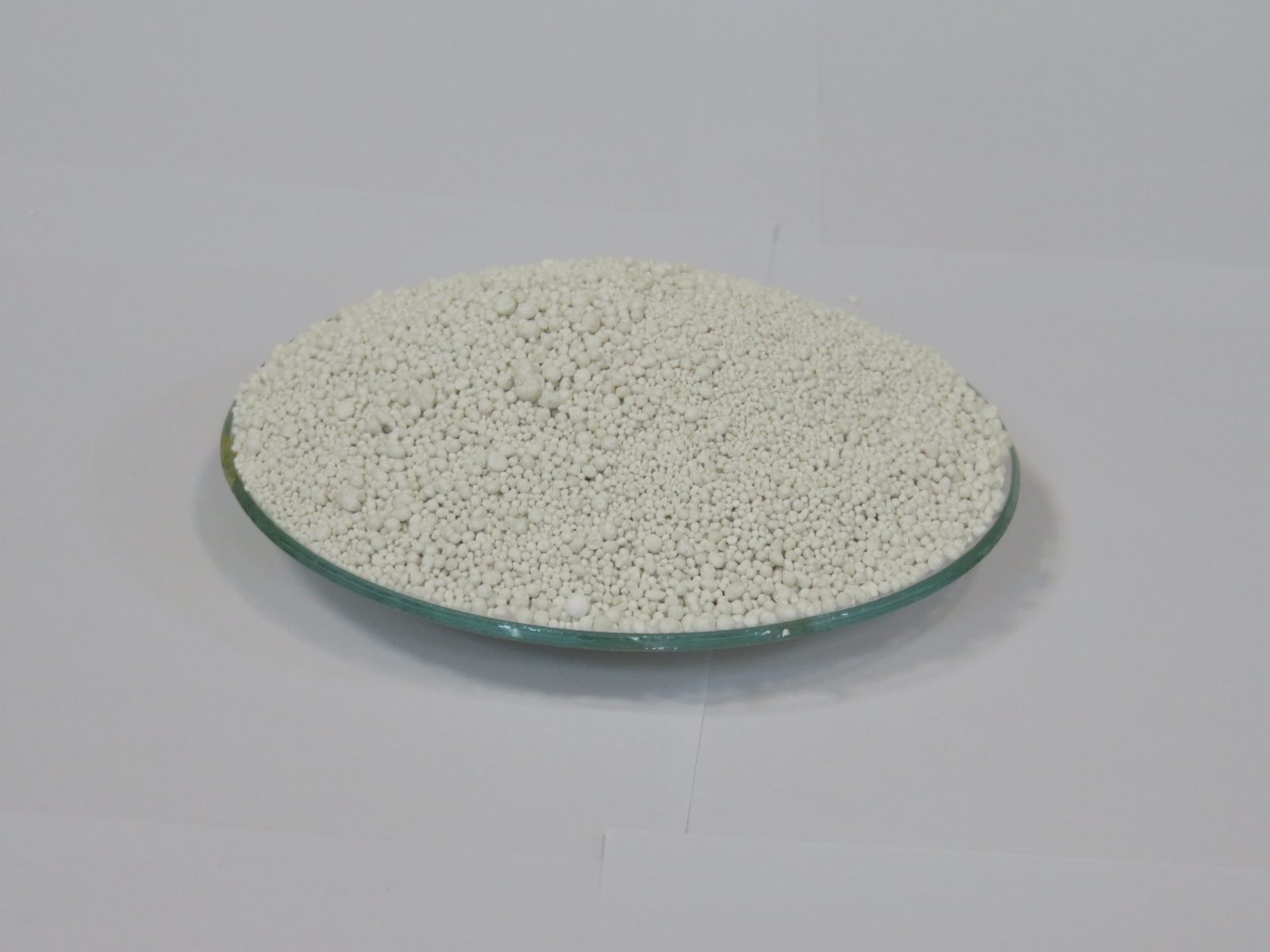 white chlorine granules heaped on a watch glass